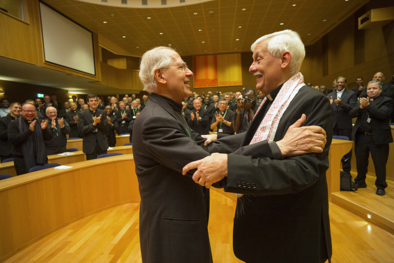 Jesuit Father Arturo Sosa, right, the new superior general of the Society of Jesus, greets the previous superior general, Jesuit Father Adolfo Nicolas, after his election in Rome Oct. 14. Father Sosa, 67, is a member of the Jesuits' Venezuelan province. (CNS photo/Don Doll, S.J.) See JESUITS-ELECTION-GENERAL Oct. 14, 2016.